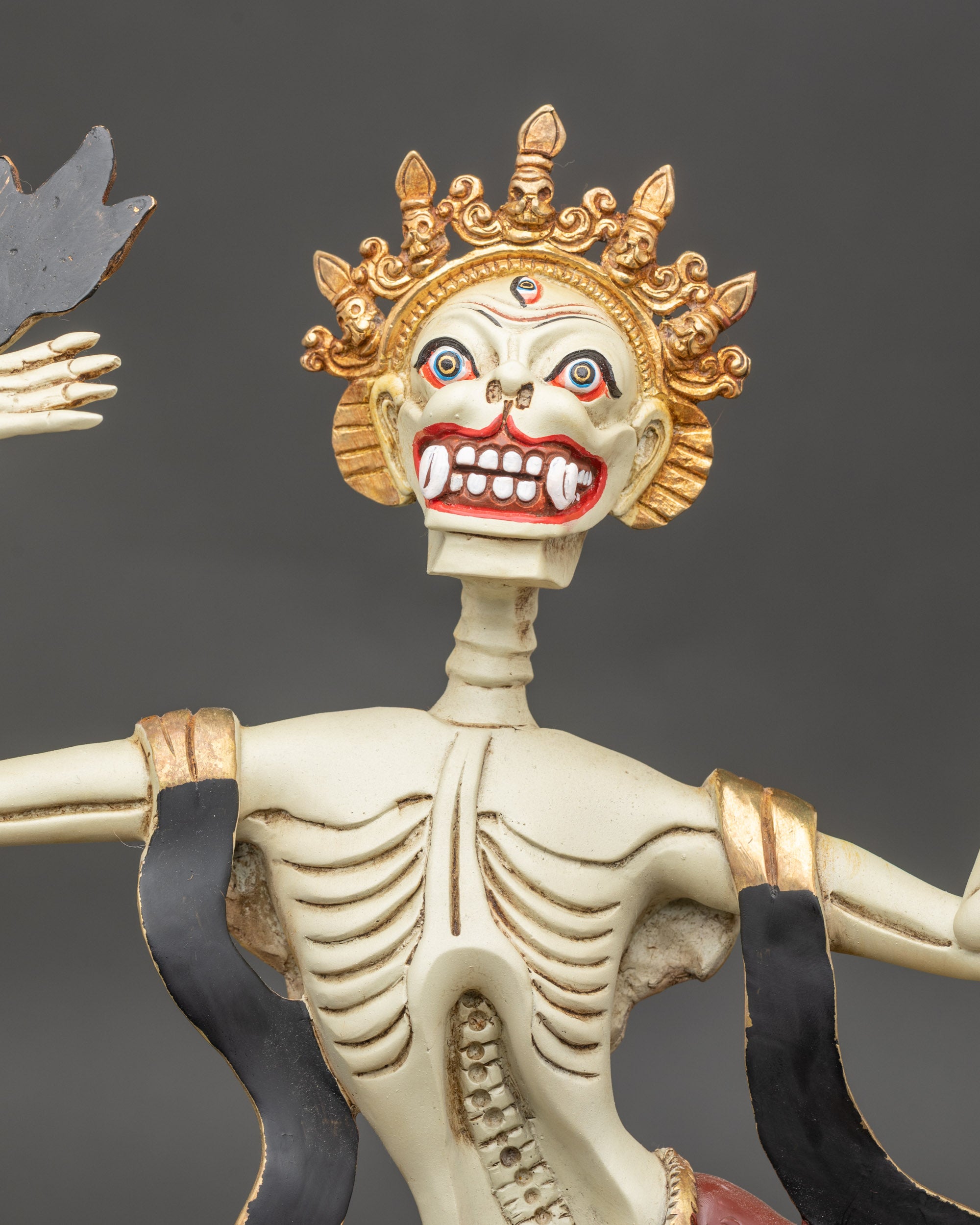 Detailed side close up of Citipati Sculpture showing flowing robes and skullcup

