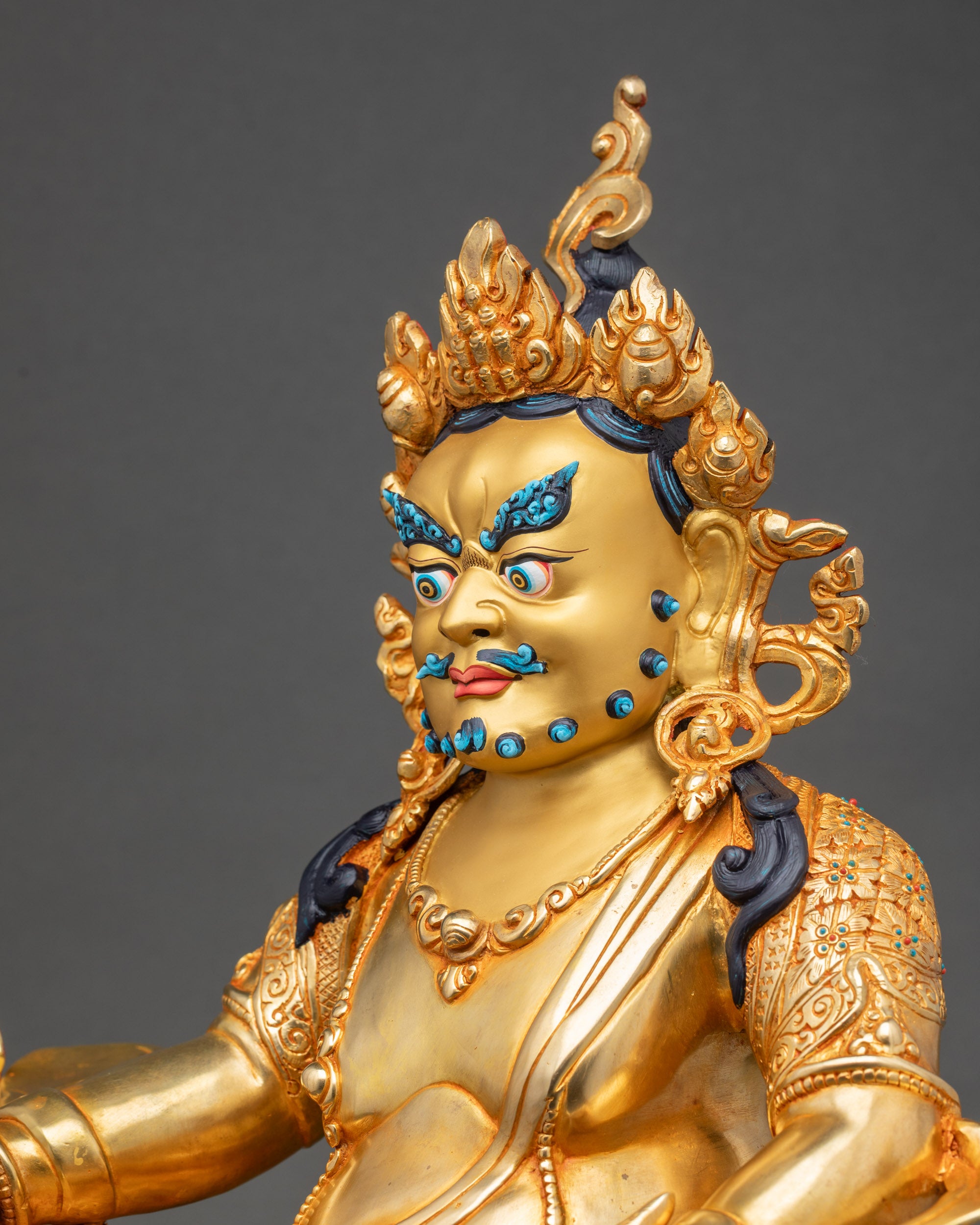 Detailed side close up of Dzambhala Statue showing citron fruits and mongoose
