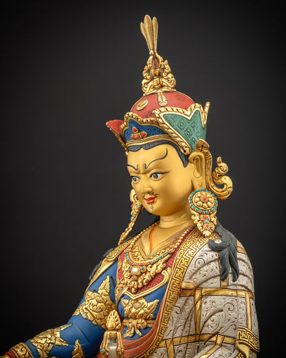Detailed side close up of Guru Padmasambhava statue with royal layered monastic robes