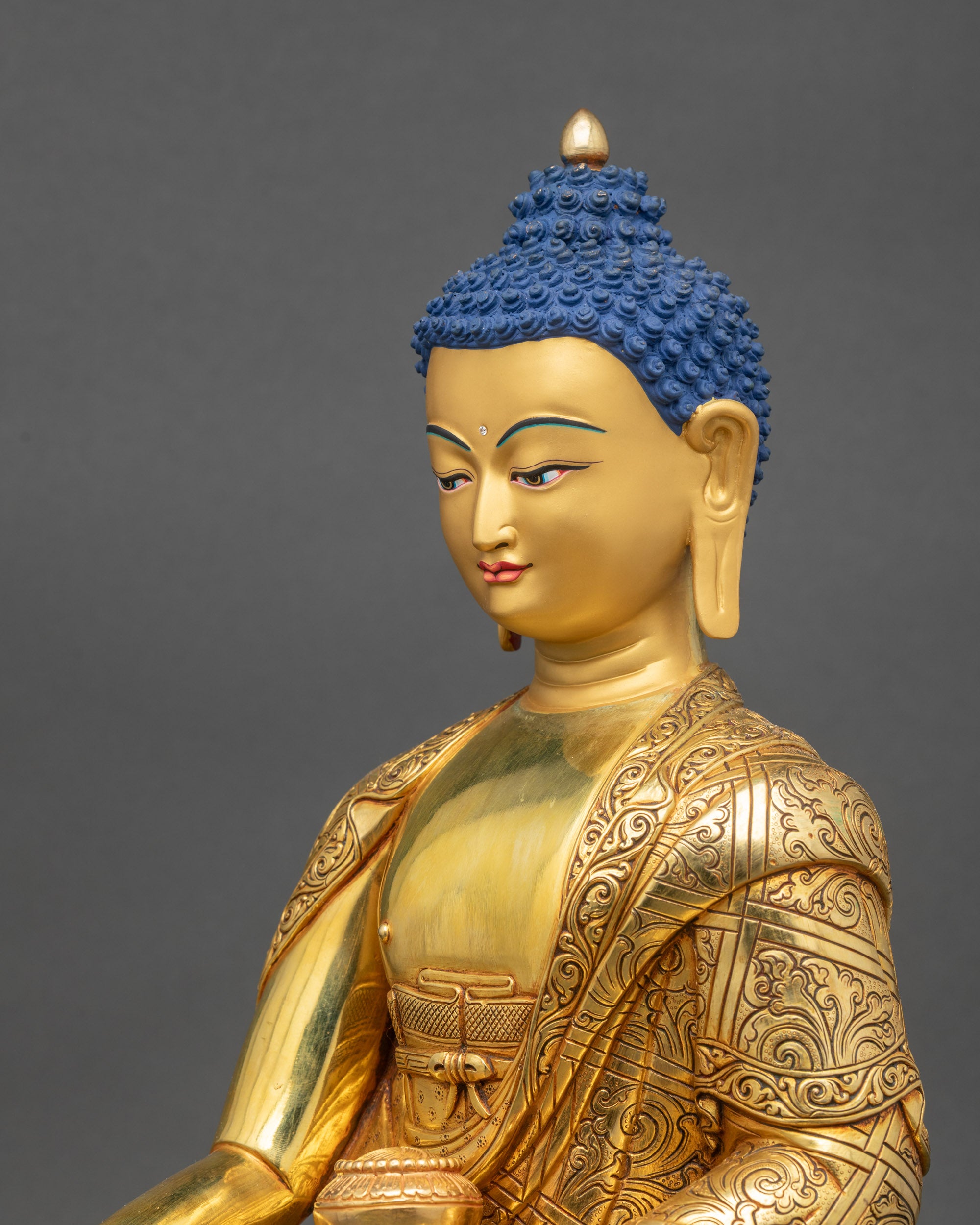 Detailed side close up of Shakyamuni Buddha statue with lotus seat
