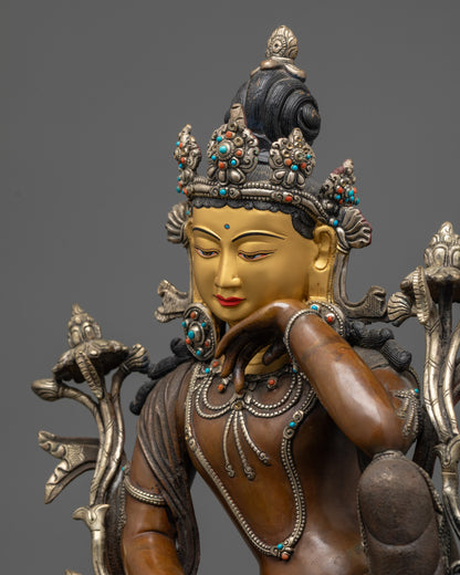Detailed side view of Chenrezig statue showing silver-plated robe and patterned garments