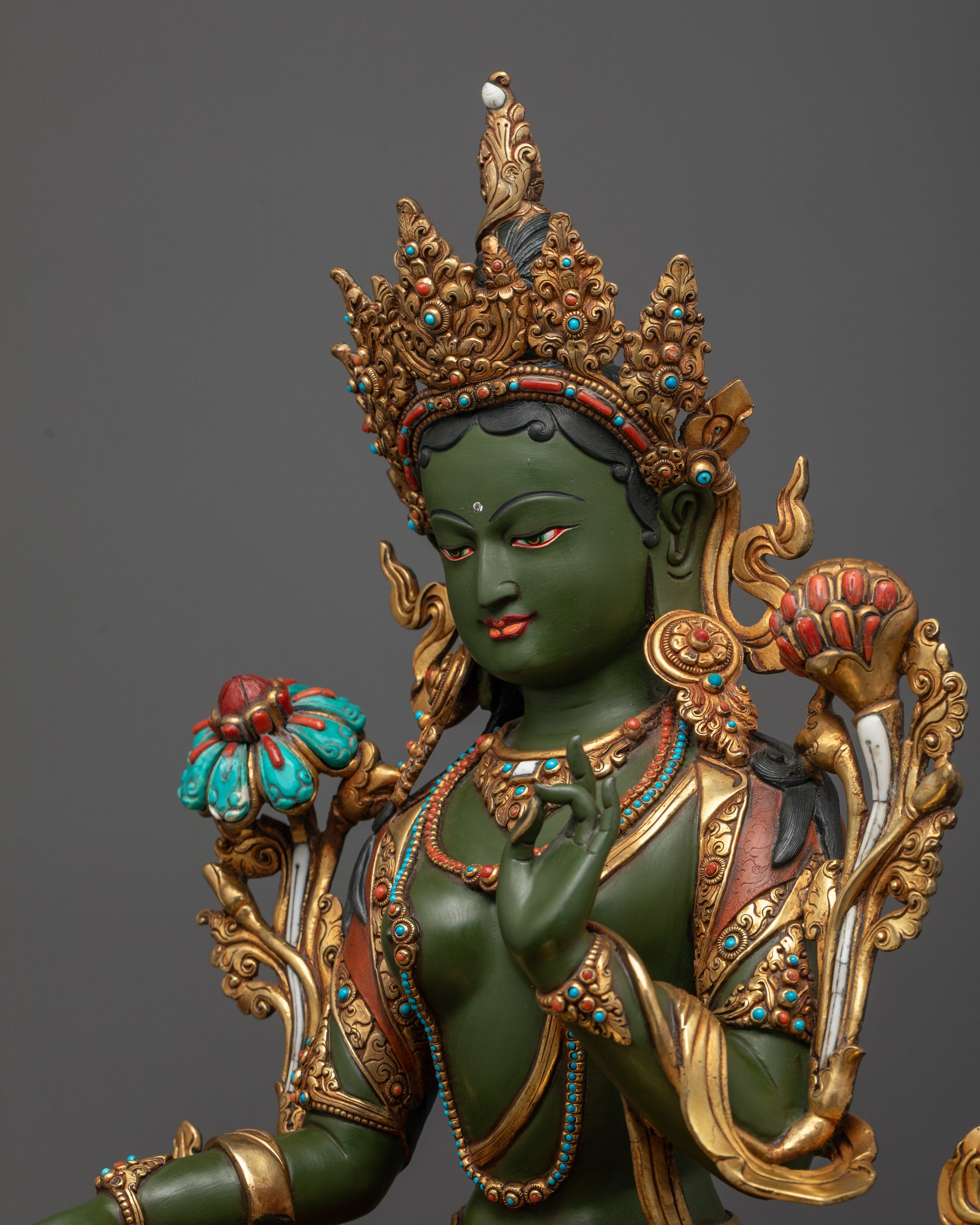 Detailed side view of Green Tara statue with gold-plated floating robe
