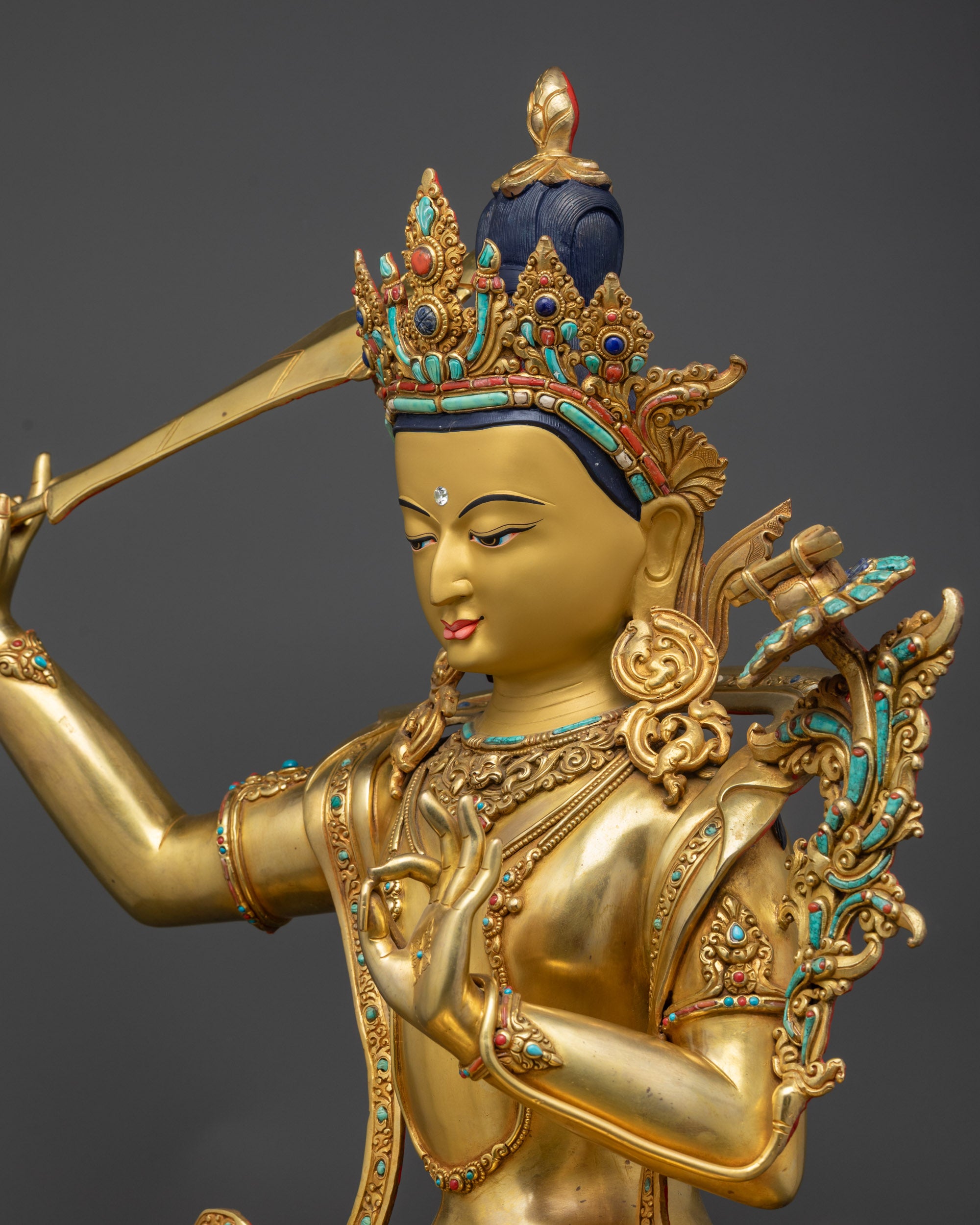 Detailed side view of Manjushri statue showcasing carved swirling robe patterns
