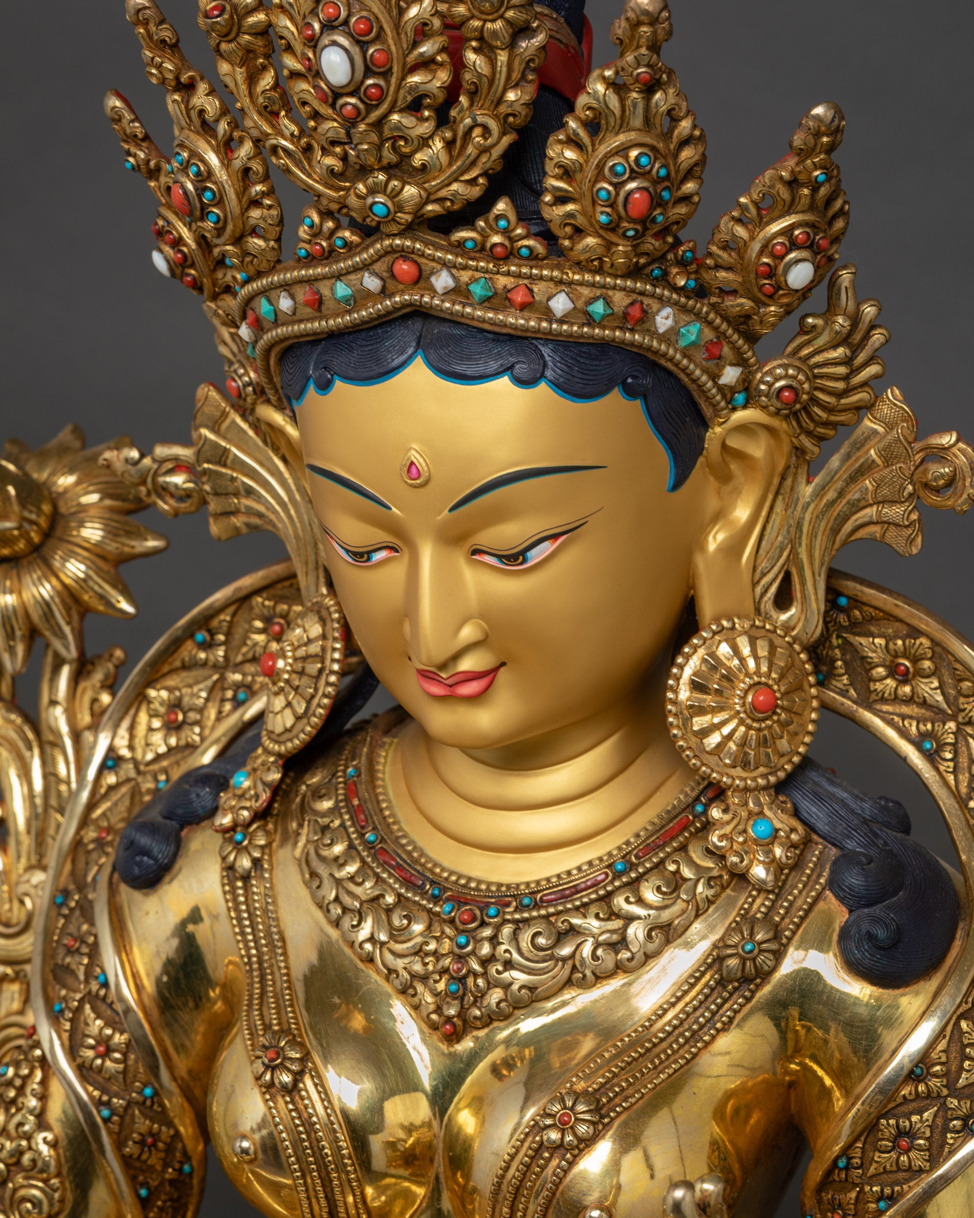 Detailed upper view of Green Tara Statue showing crown, face, and gold fire-gilded details