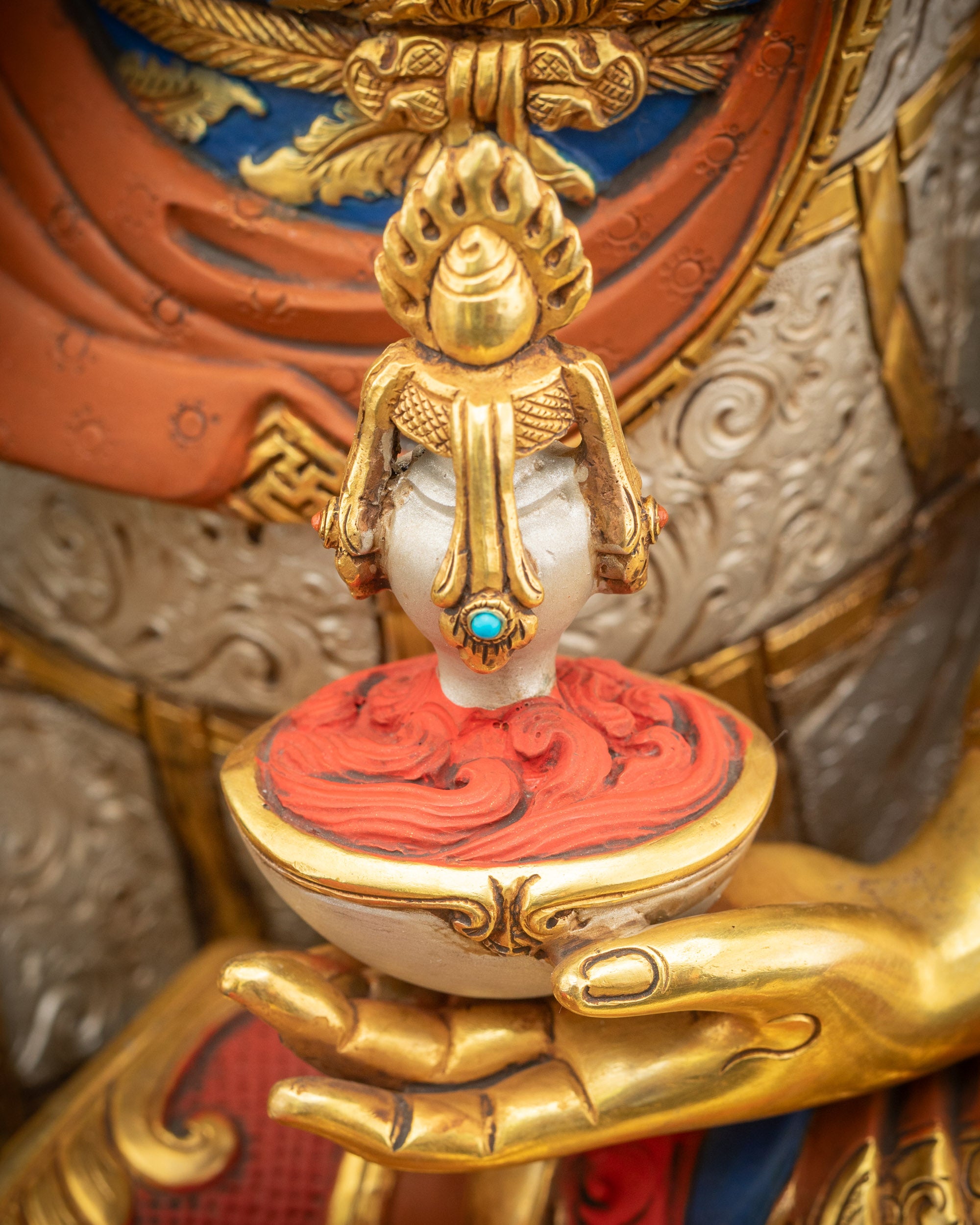Detailed view of Guru Padmasambhava holding skull cup with vase of immortality