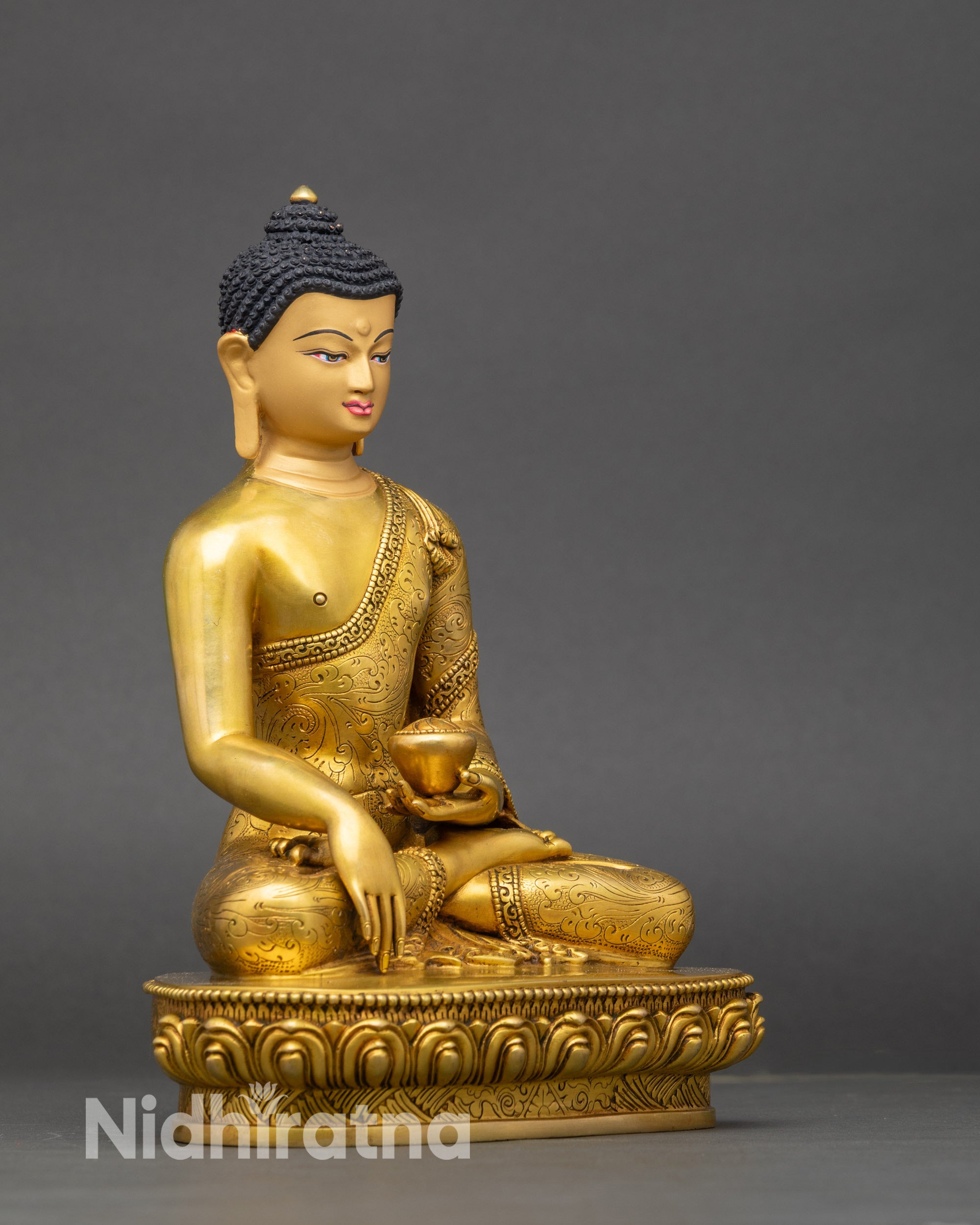 Detailed view of Shakyamuni Buddha’s serene face, featuring radiant 24K gold fire-gilding and peaceful expression.