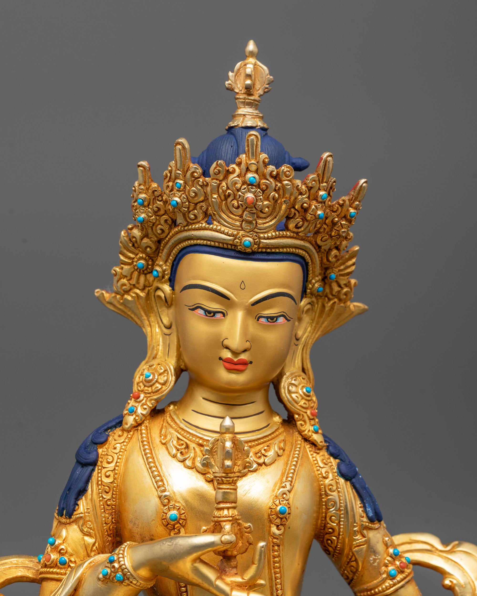 Detailed view of Vajrasattva statue’s face polished with pure 24k gold