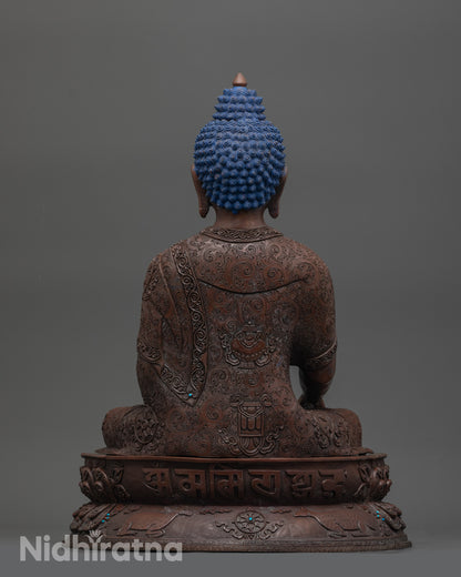 Detailed view of bhumisparsa mudra hand gesture on handcrafted oxidized copper statue
