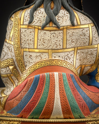 Detailed view of flowing monastic robes on Guru Rinpoche statue