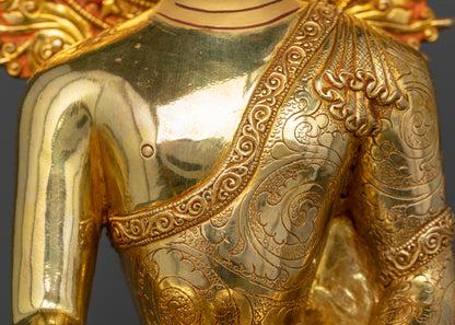 Detailed view of flowing robes with intricate patterns on Shakyamuni Buddha figurine