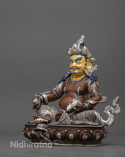 Detailed view of gold-gilded face and silver-plated finish on oxidized copper Dzambhala Statue