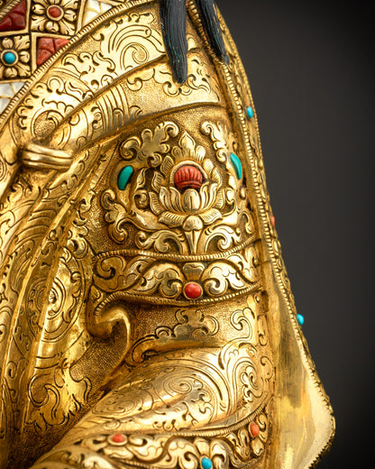 Detailed view of robe with turquoise, coral, white stone, and lapis inlays
