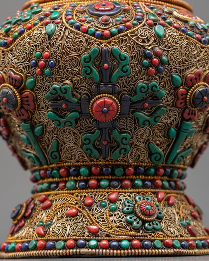 Detailed view of vishwa vajra on ricepot body highlighting coral, turquoise, and lapis lazuli inlays