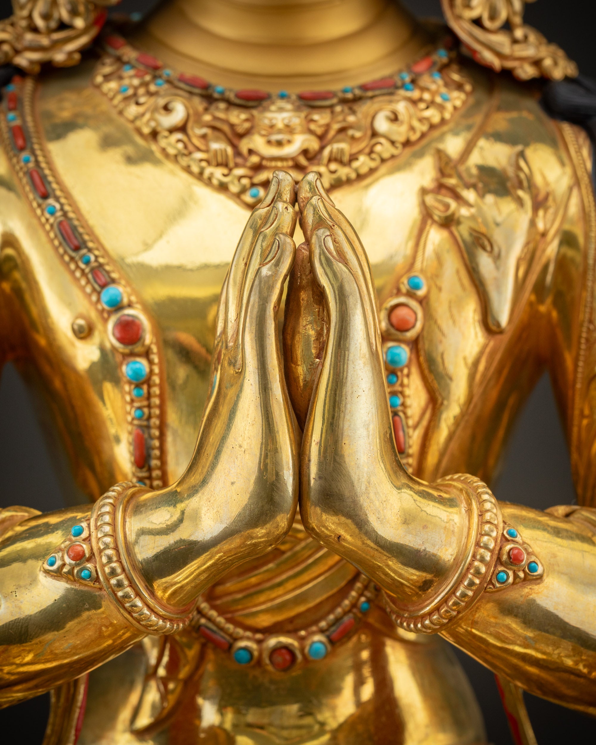 Detailed wish-fulfilling gem held in Chenrezig Statue representing purity and enlightened intention
