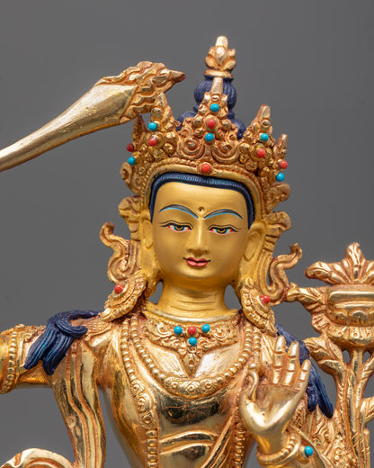 Double-edged sword and Utpala flower in Vitarka Mudra, close-up of Manjushri sculpture details