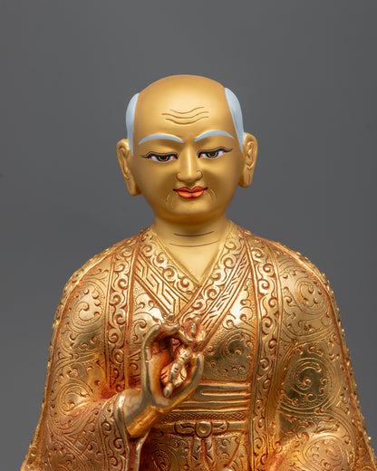 Drakpa Gyaltsen statue holding a vajra and bell for tantric balance.