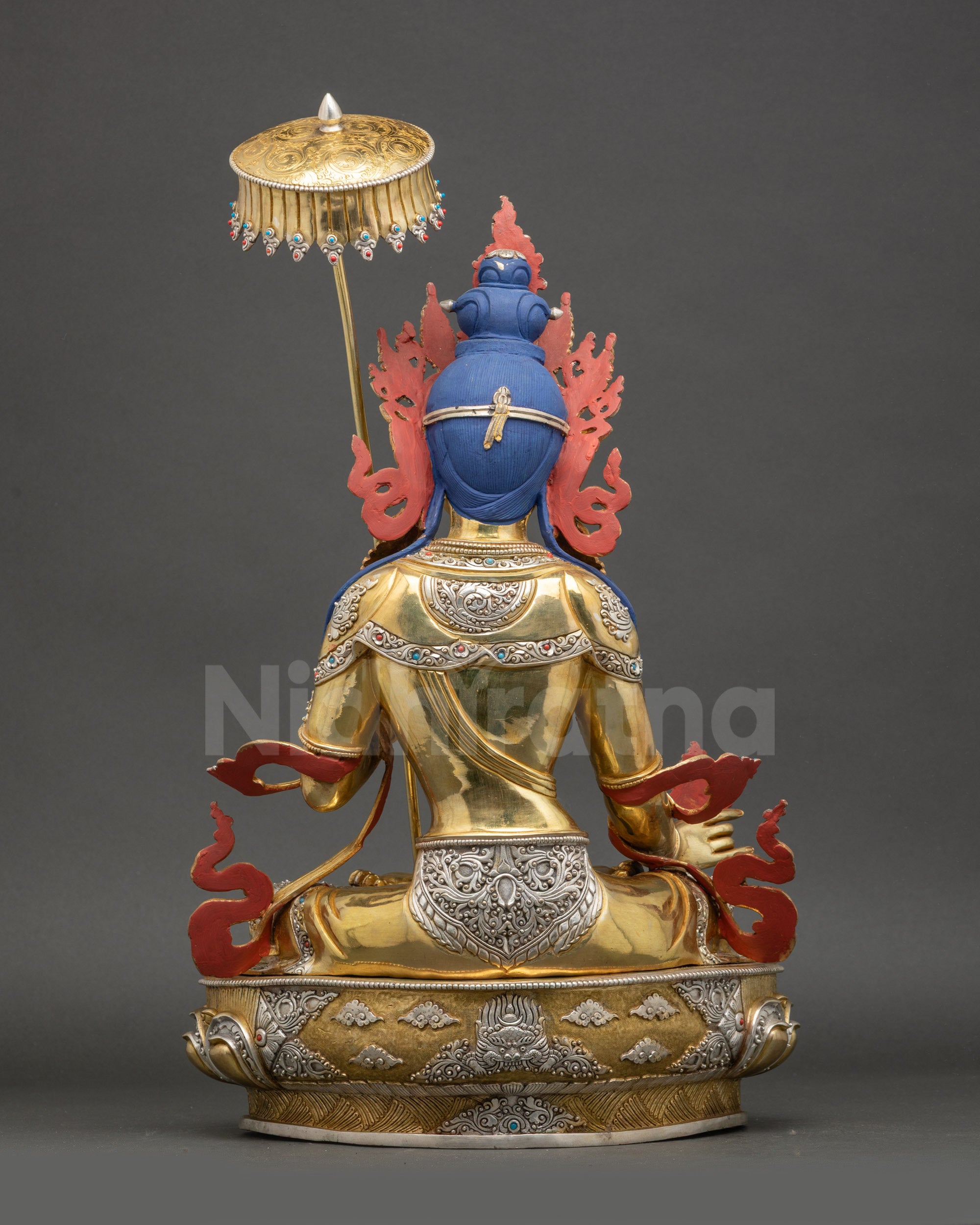 Dukar statue back view flowing robe sun disc ornate detailing