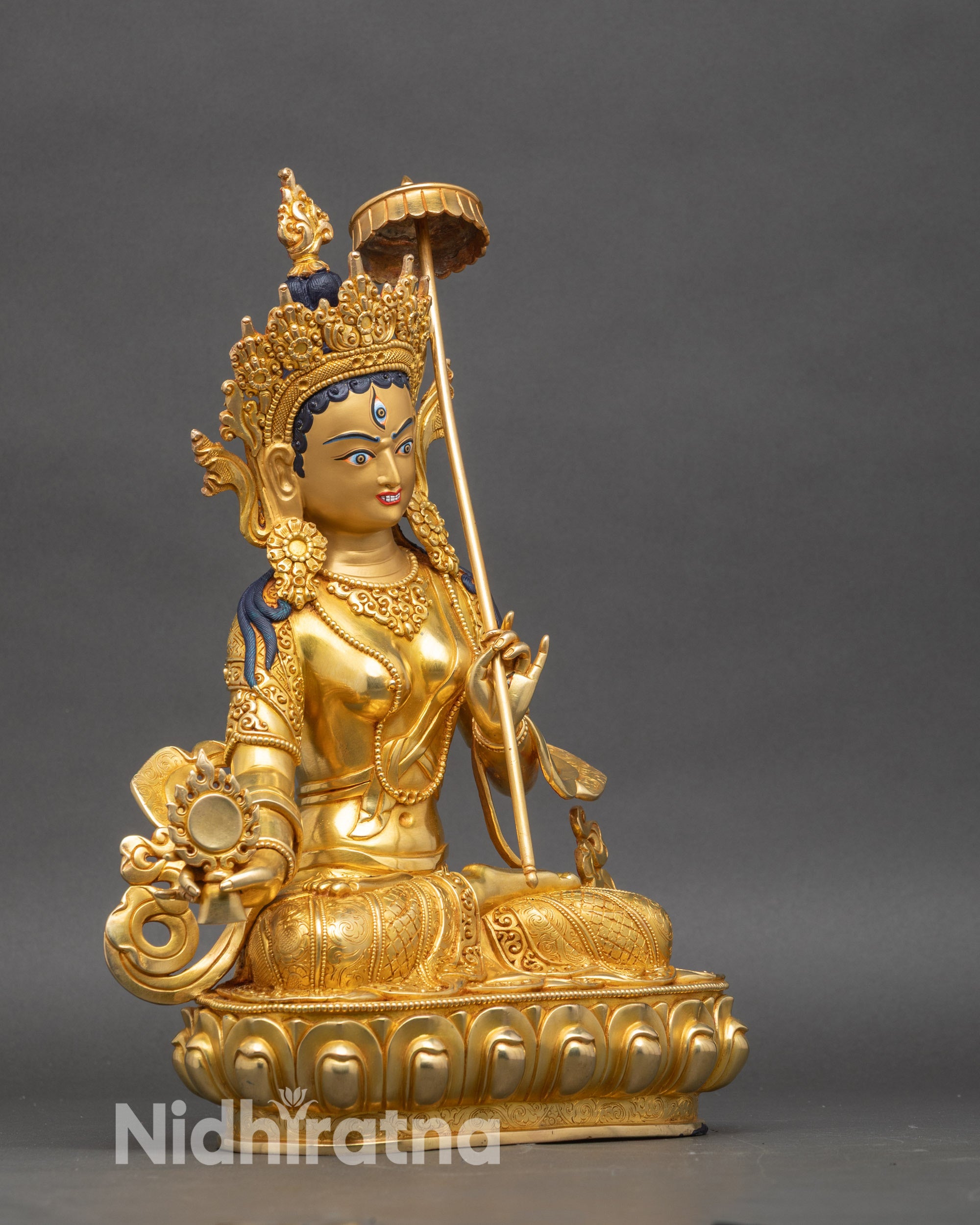 Dukar statue right profile, lotus pedestal, copper and gold finish, holding parasol