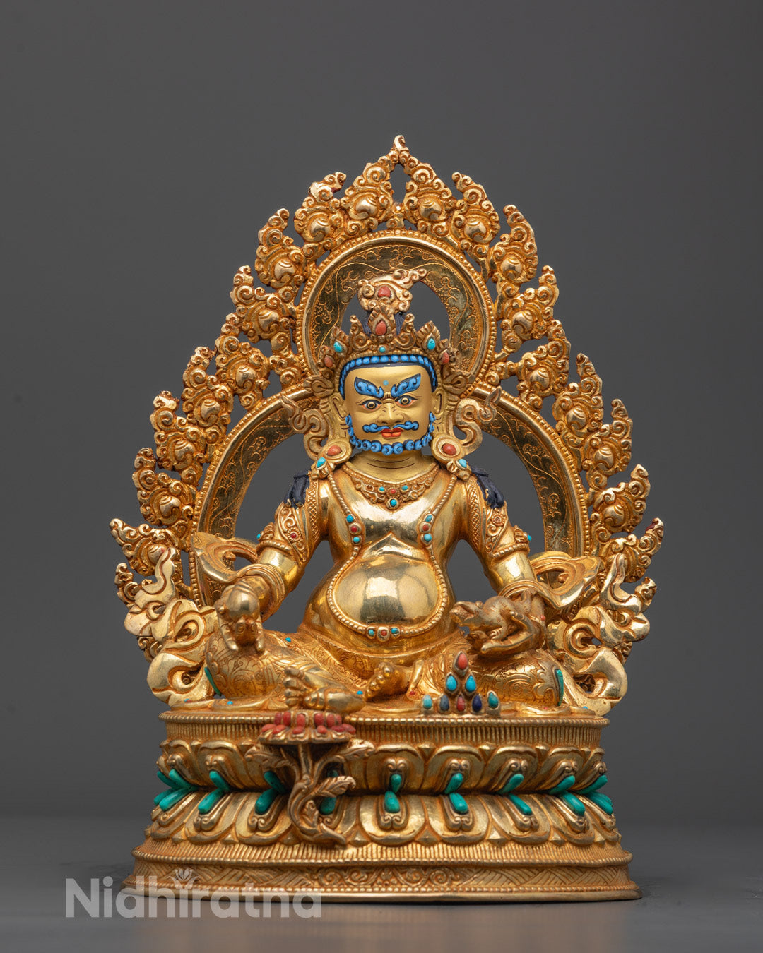 Front view of hand-carved Dzambhala Statue seated on lotus base with gold gilding

