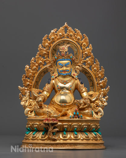 Front view of hand-carved Dzambhala Statue seated on lotus base with gold gilding

