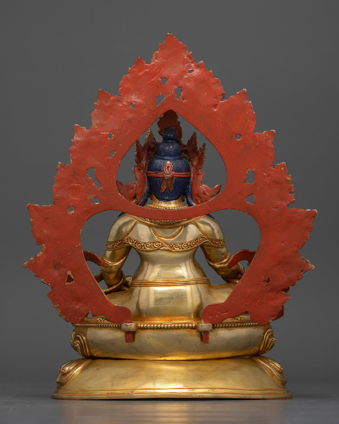 Back view showcasing the intricate detailing on the deity's robe, the halo, and the design of the lotus base.