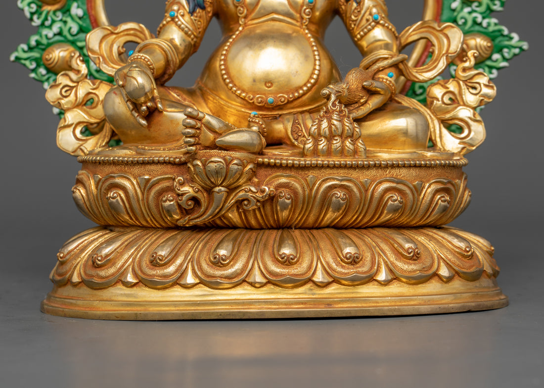 view of Dzambhala’s lower part, focusing on his hands holding sacred objects and feet resting on a lotus base.