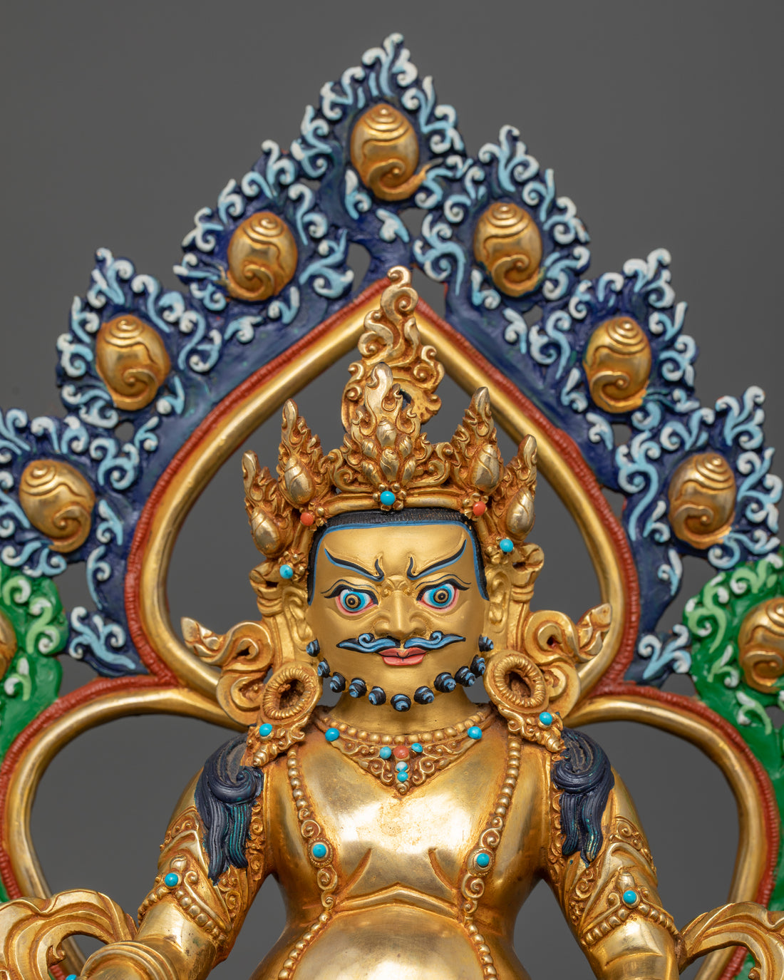 Portrait view of a Dzambhala statue, highlighting the deity’s expression, ornate crown, and detailed facial features, with a close-up of the intricate designs on the ornaments.