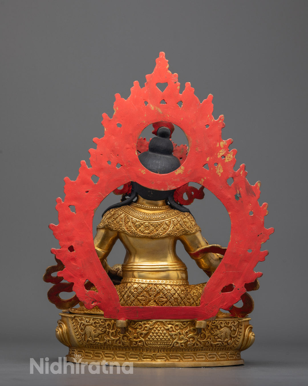 Dzambhala Statue back view featuring elaborate halo and ornate robe design