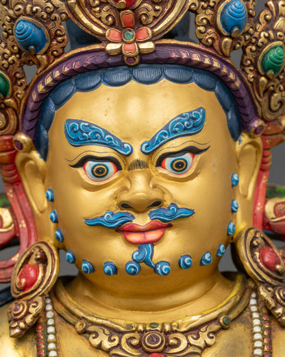 Dzambhala Statue detailed close-up of face with wrathful gold-painted expression