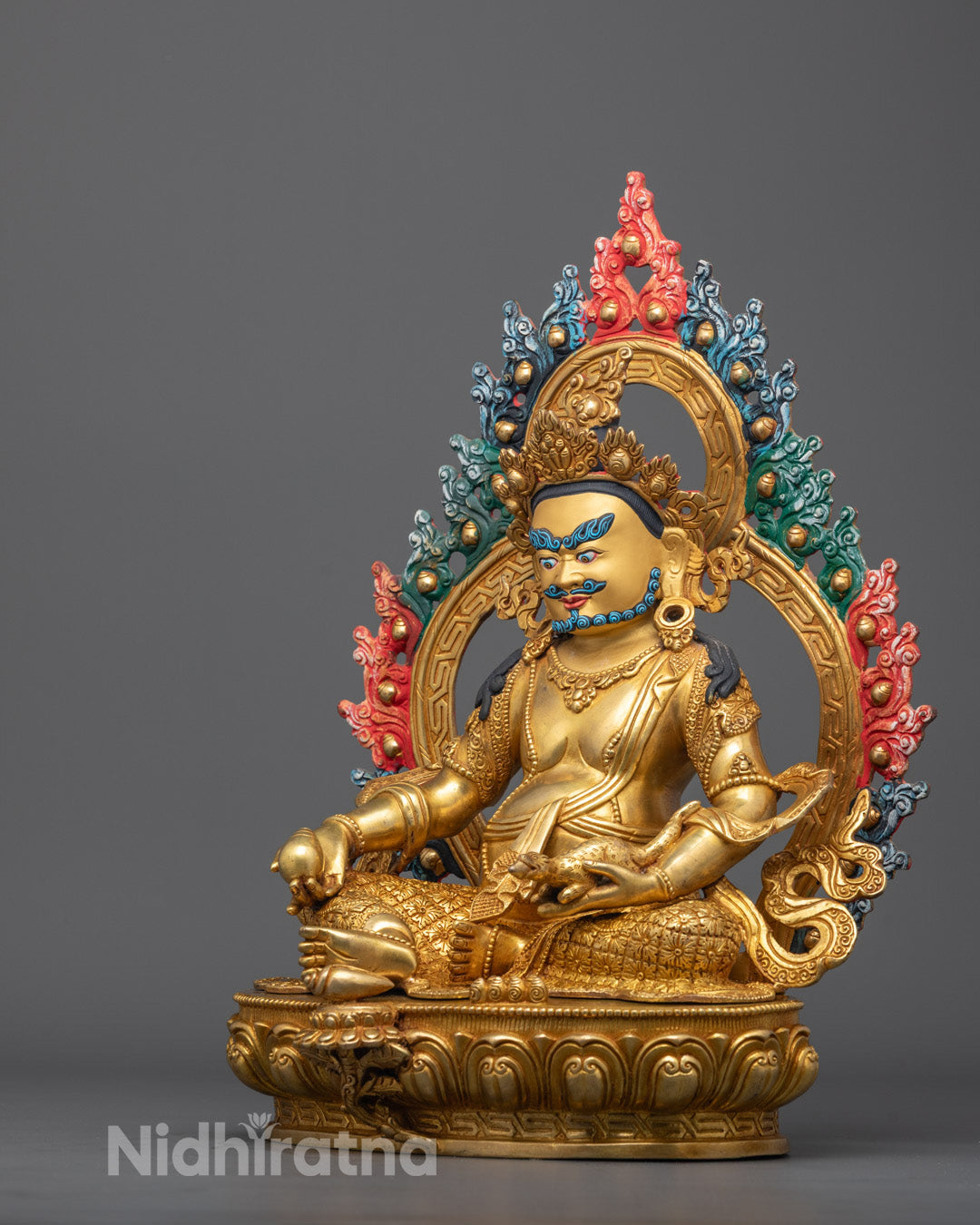 Dzambhala Statue side view highlighting robe carvings and gold fire-gilded body
