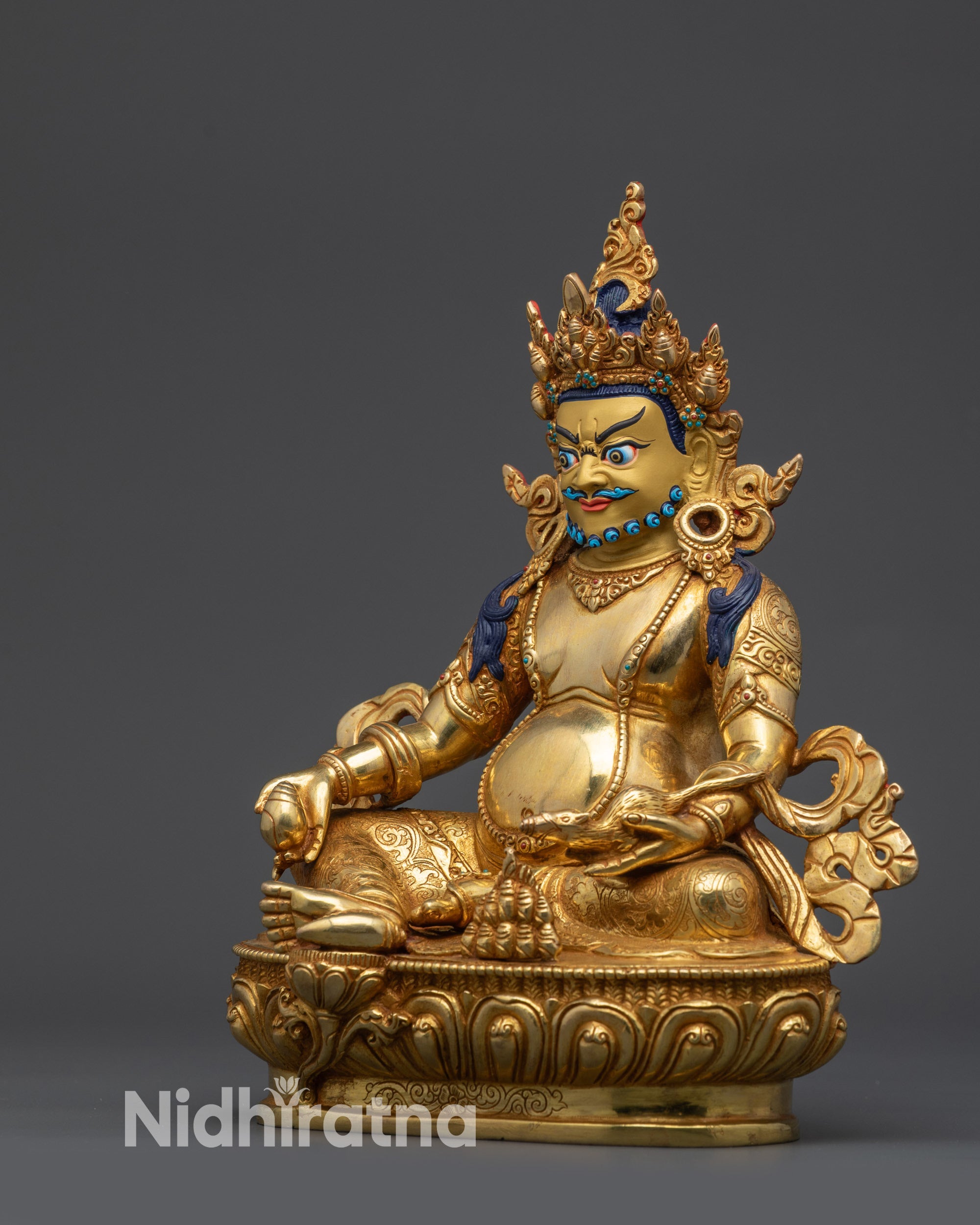 Dzambhala deity figurine spitting mongoose in royal ease pose