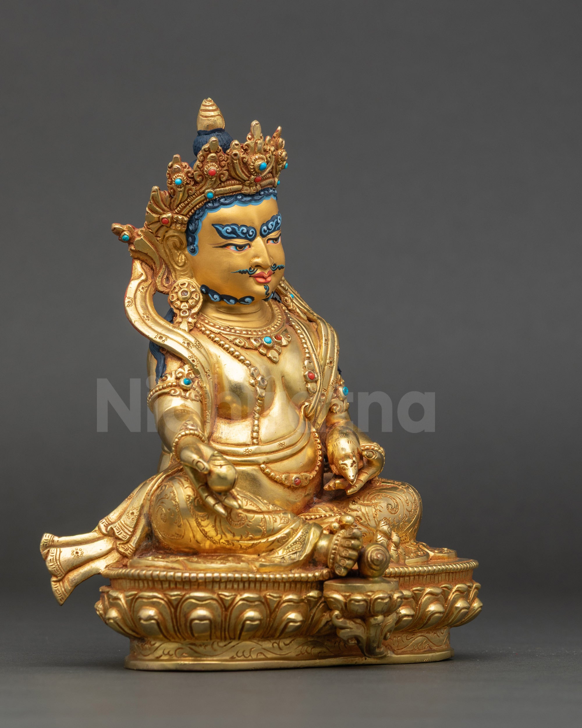 Dzambhala holding citron fruit and mongoose spitting jewels symbol of prosperity