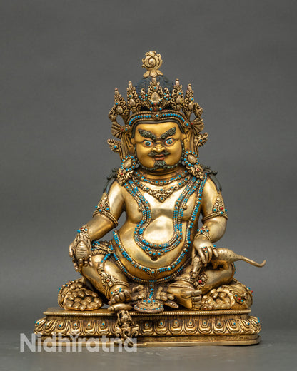 Dzambhala statue from Nepal with gold fire-gilded and jeweled crown, symbol of wealth