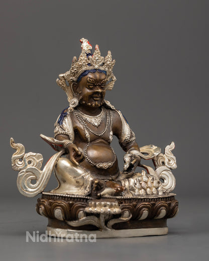 Dzambhala statue seated on a lion throne, showcasing spiritual union and abundance in Tibetan Buddhist craftsmanship.