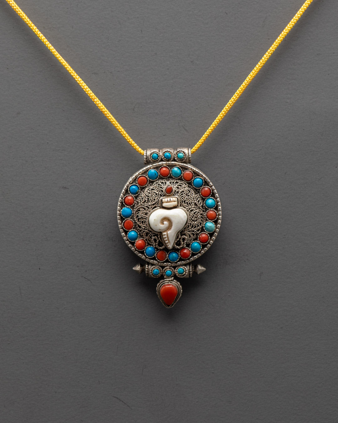 Elegant Shell Locket close-up with silver filigree and semi-precious stones, handcrafted in Nepal