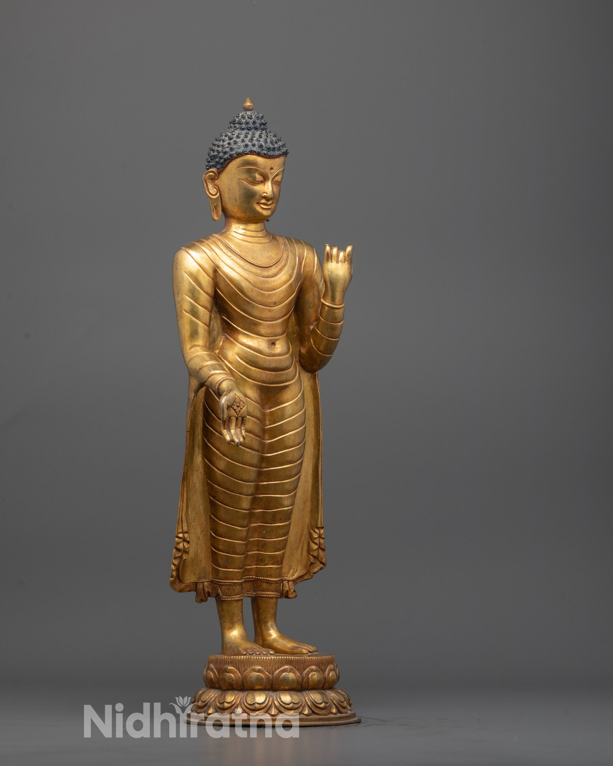 Elegant Standing Buddha statue featuring traditional lost wax method carving
