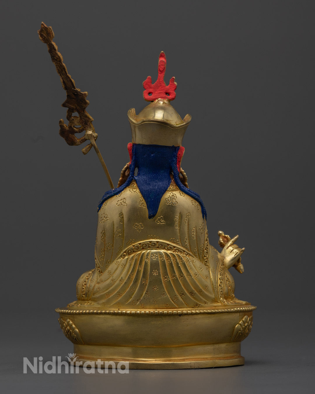Enhance your spiritual space with this 24.5cm tall Guru Rinpoche statue, handcrafted in Nepal with intricate carvings and a gold-plated finish, symbolizing spiritual mastery and devotion.