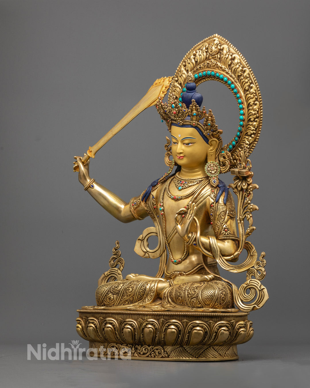Exquisite 24k gold-gilded Manjushree statue holding the sword of wisdom, with a beautifully detailed lotus seat and radiant back halo.