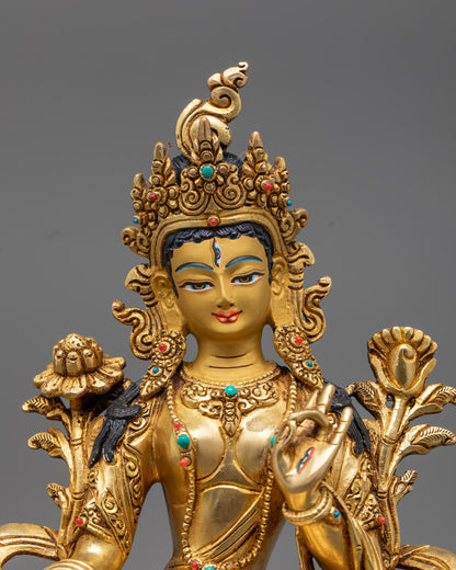 Exquisite hand-carved face of the White Tara statue with gold gilding and semi-precious stone eyes, radiating divine compassion