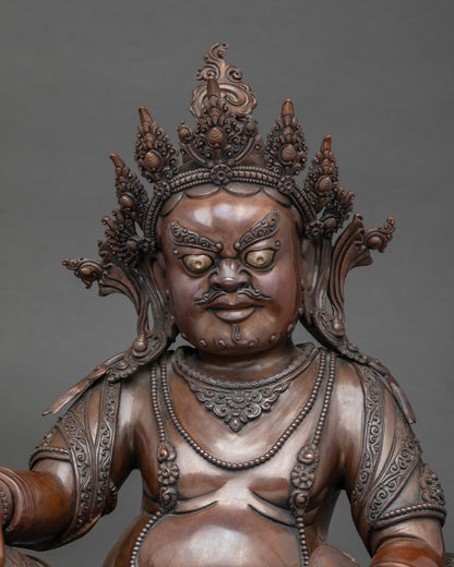 Close up Dzambhala Buddha face with five-point crown and jewelry, handcrafted Nepalese art