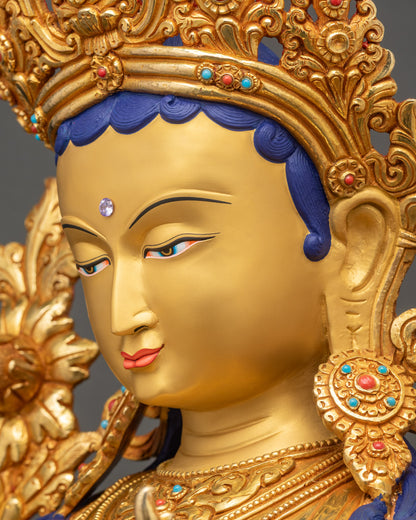 Green Tara statue side face close up with refined facial features and gilded finish