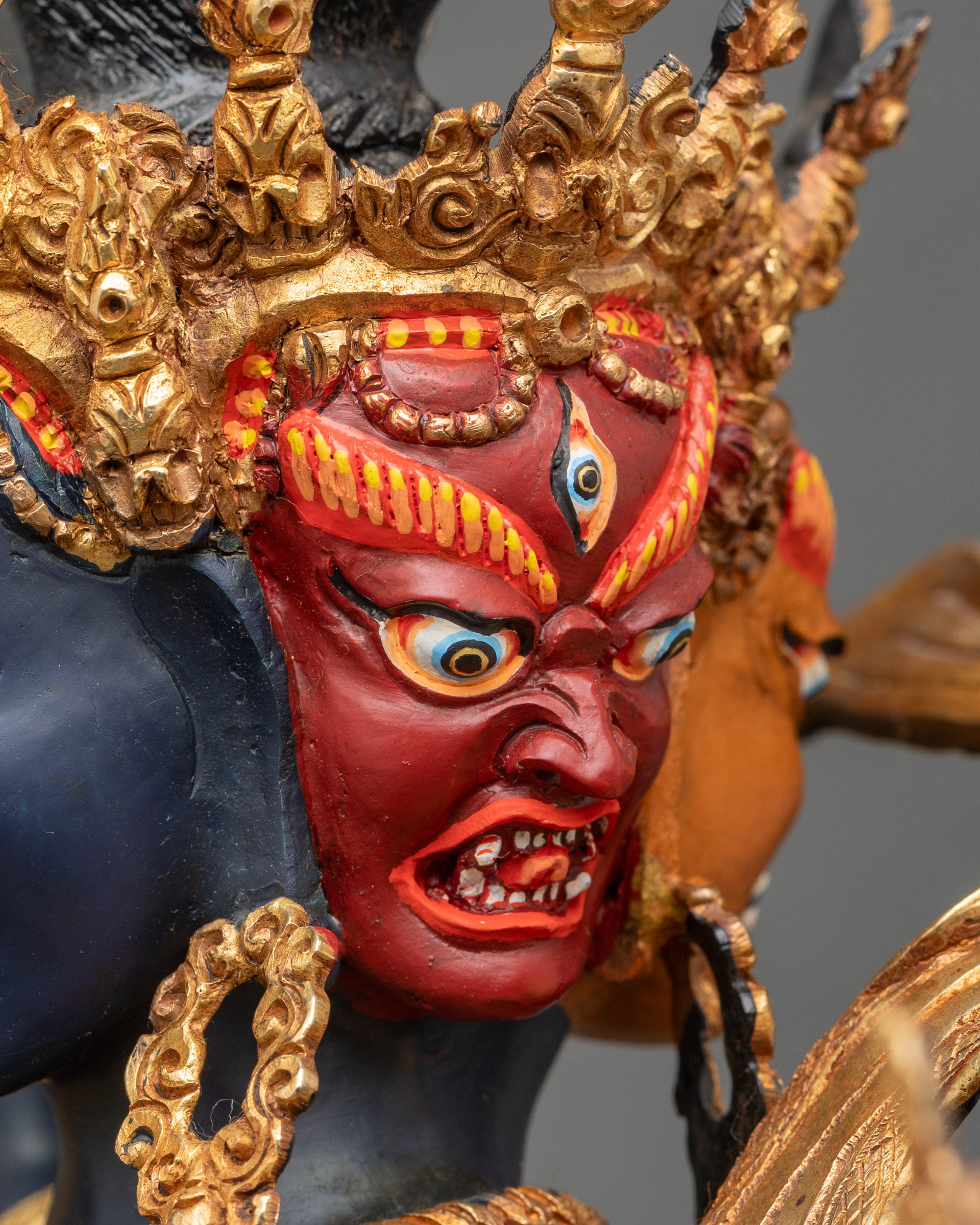 Side face close-up of Kalachakra, four heads, twenty-four arms, gold finish