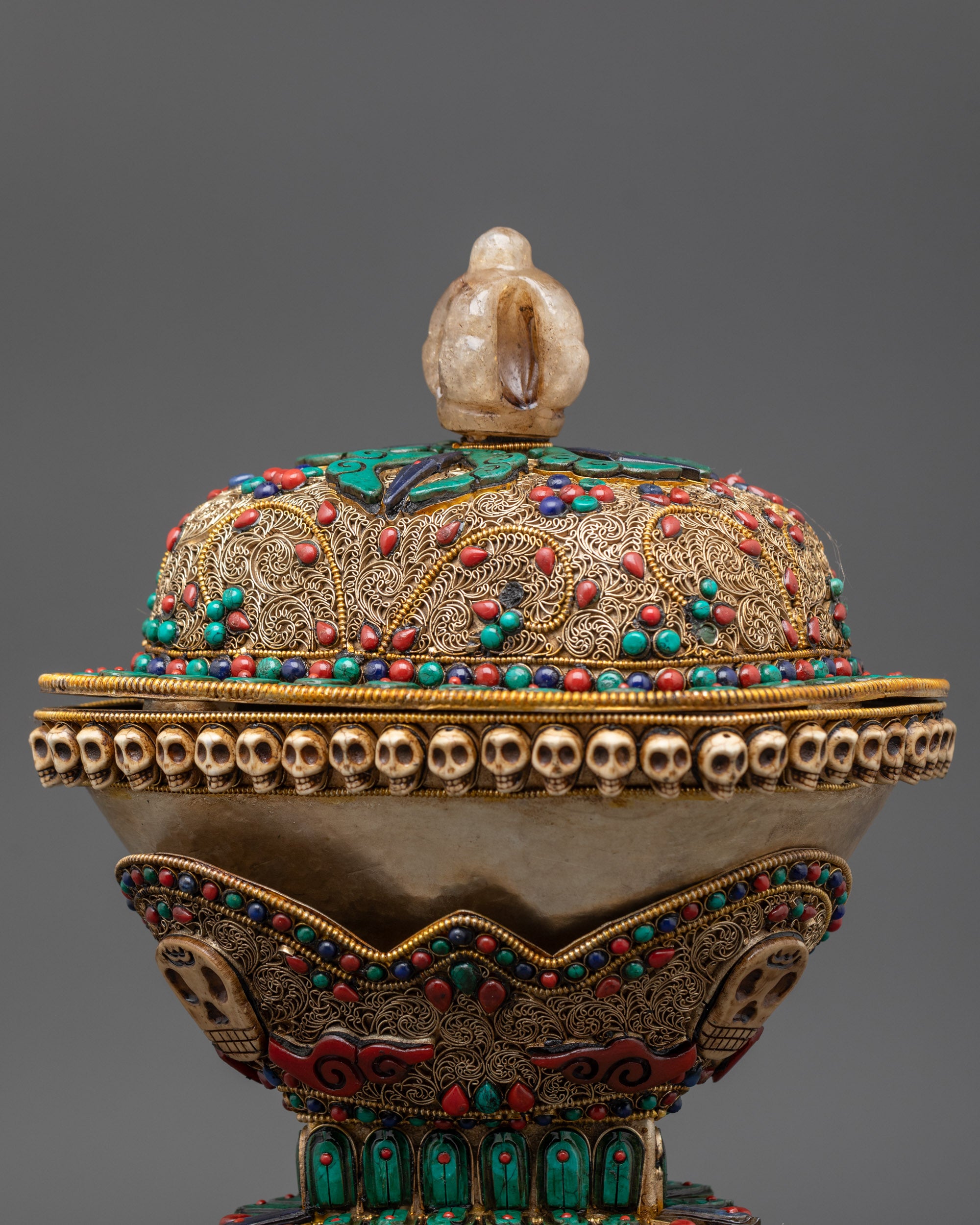 Back view of Tibetan Kapala with copper base and intricate stone patterns