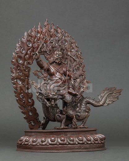 Side view White Dzambhala sculpture, seated on lotus base atop legendary dragon