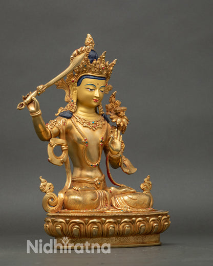 Side view Manjushri statue highlighting lotus seat, flowing robes, and sacred carvings