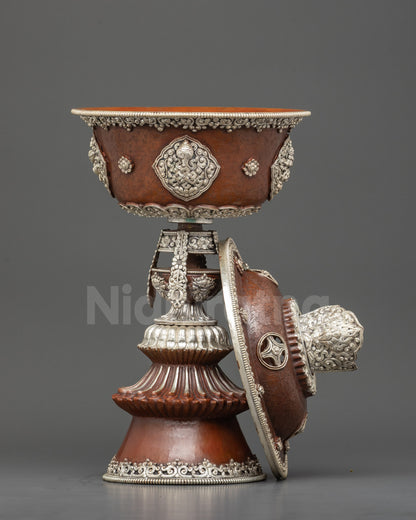 Close up decorative silver finial on Tibetan Butter Lamp symbolizing enlightenment and blessings