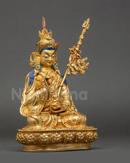 Side view Guru Tsokye Dorje statue holding vajra kalash khatvanga staff