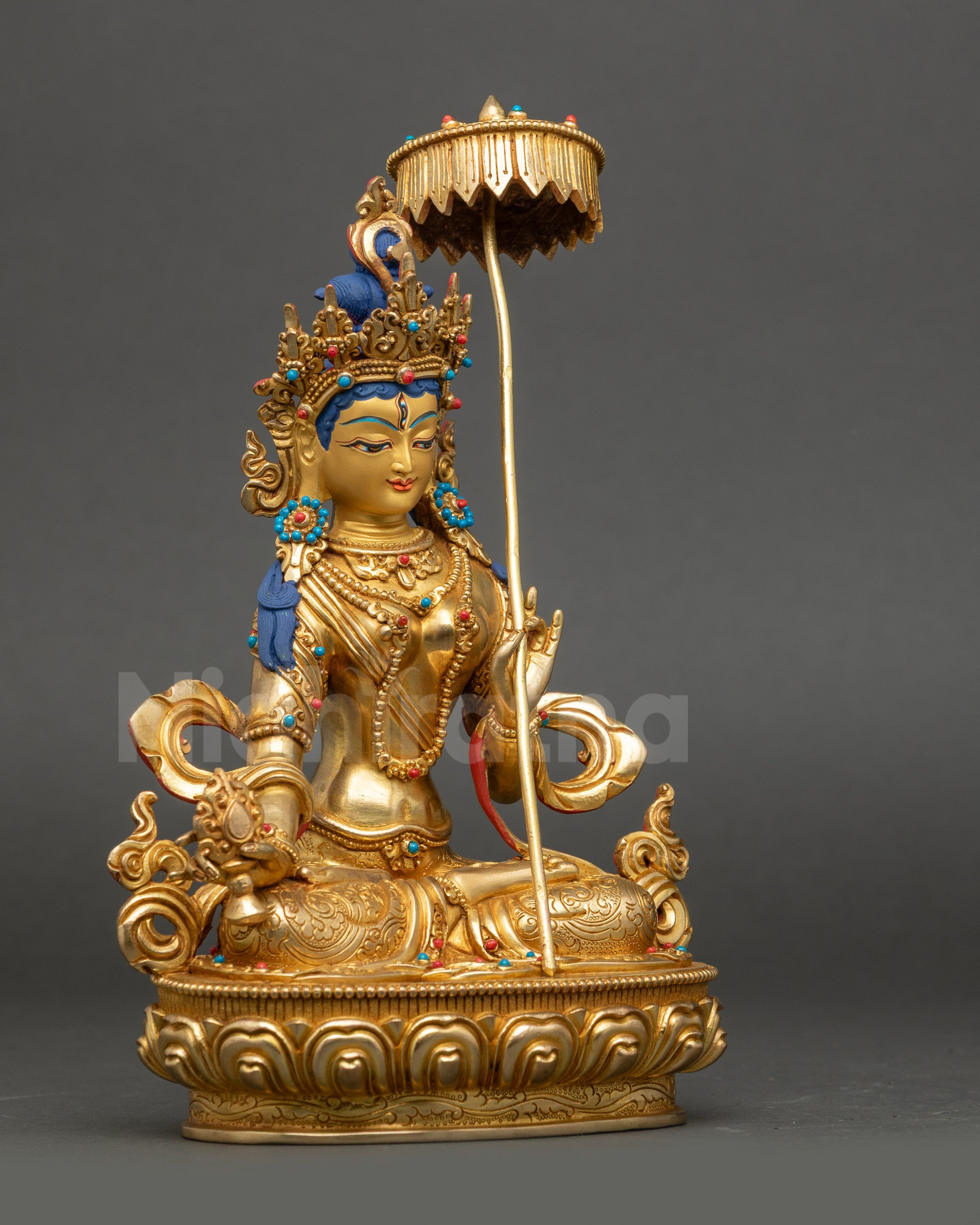 Dukar Dakini holding white parasol and Dharma Wheel Buddhist sculpture