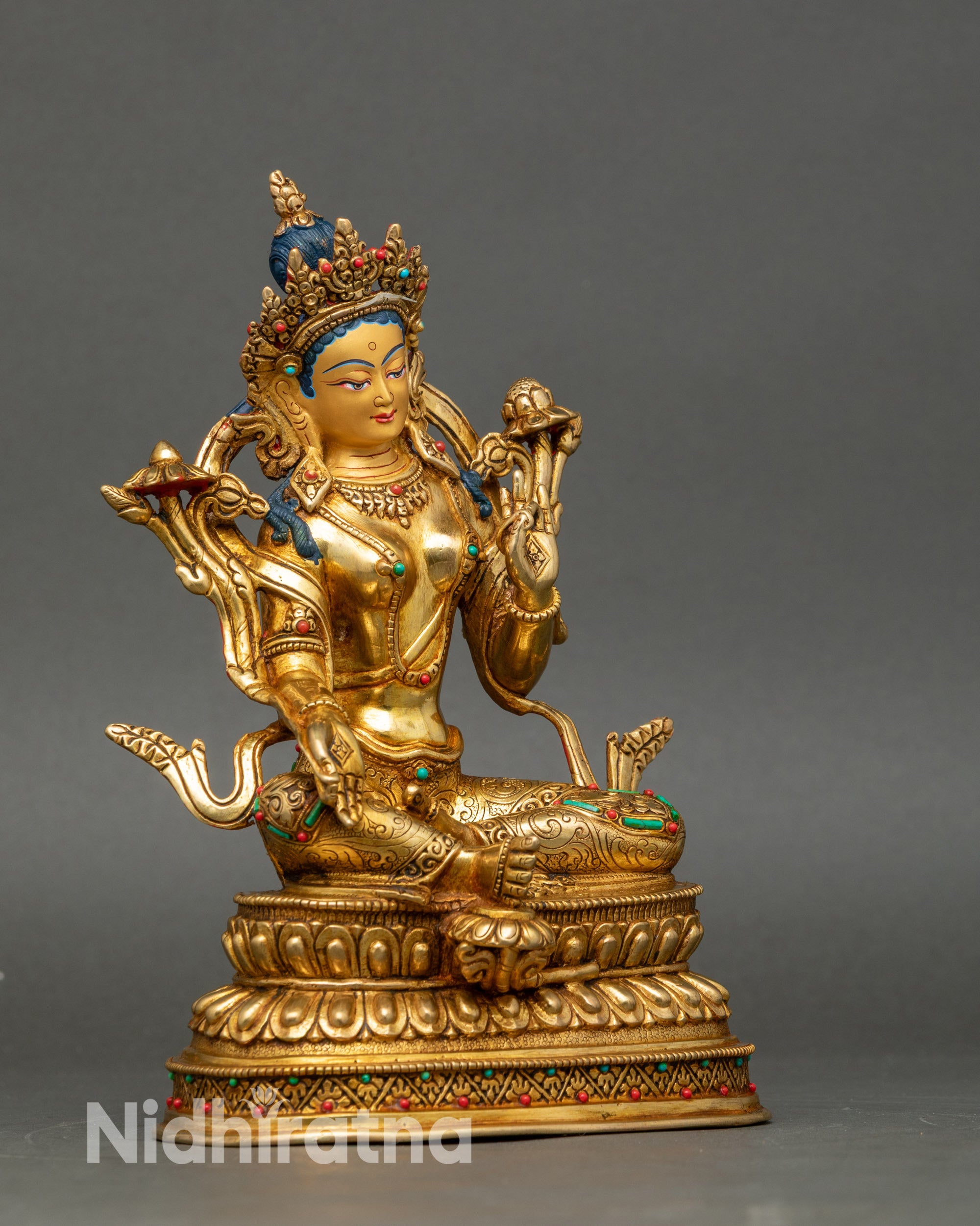 Side view Green Tara statue seated with right leg extended, left leg meditative, sacred decor