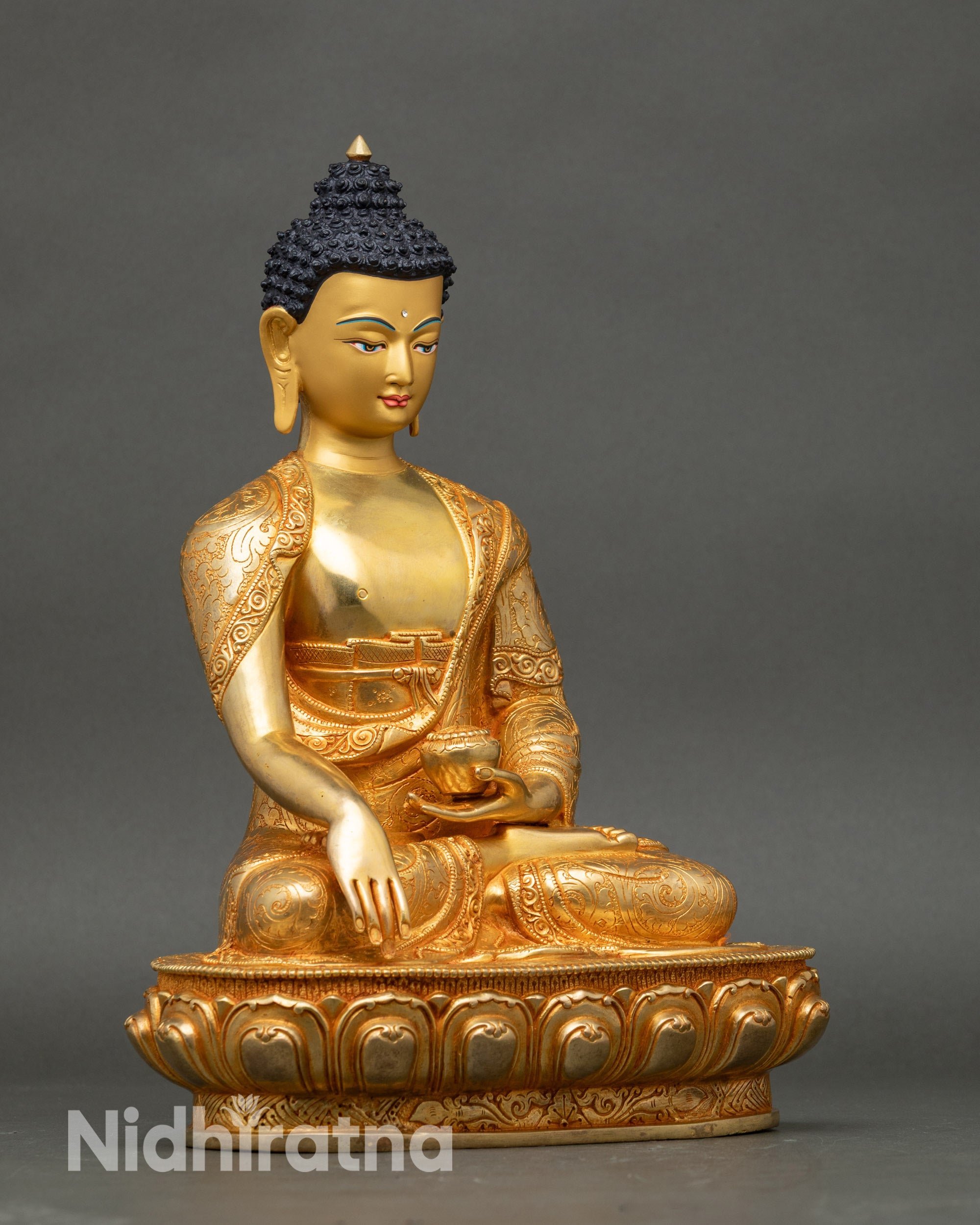 Side view Shakyamuni Buddha statue highlighting carved garments and lotus throne